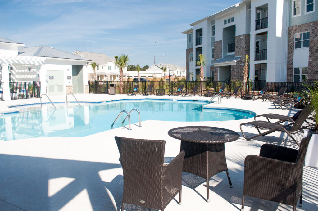 pool area with lounge chairs and seating