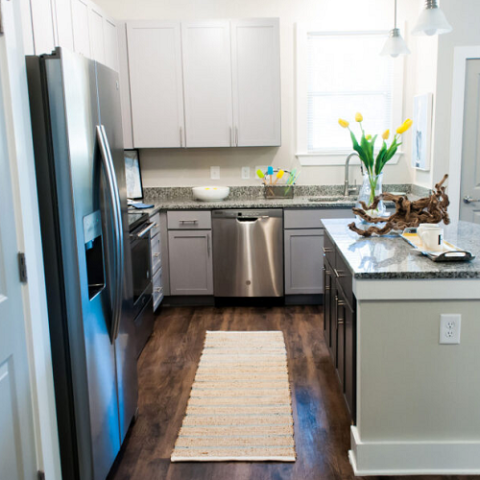 kitchen are with island, stainless steel appliances, and wood-like flooring